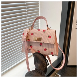 Detail of pink corduroy mini bag with strawberry embroidery and metal twist lock