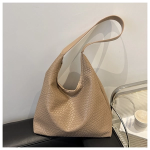 Detail of woven texture and premium PU leather finish on a vintage apricot tote bag