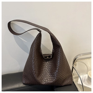 Macro shot of dark brown woven texture on a vintage hobo bucket shoulder bag