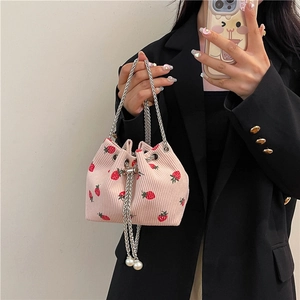 Pink corduroy bucket bag with red strawberry print and elegant pearl chain strap