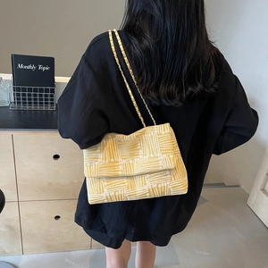 Vintage yellow canvas shoulder bag with geometric pattern and gold chain strap