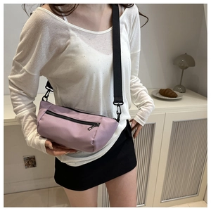 Minimalist light purple nylon crossbody bag with adjustable black strap and dual zippers