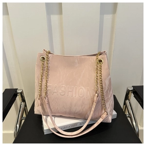 Close-up of pink tote bag with FASHION embossing and crinkled texture detail