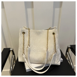 Detail of off-white wrinkled leather tote with embossed FASHION text and gold chain
