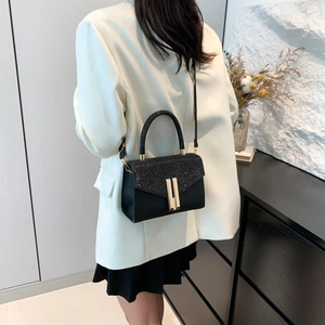 Elegant black sequin crossbody bag with gold buckles and leather strap for women
