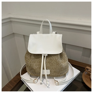 Detail of straw woven backpack with white leather flap and gold metal buckle hardware
