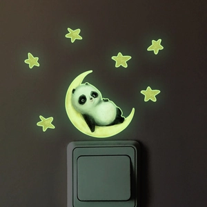 Luminous wall sticker showing a cute panda on a crescent moon glowing above a light switch