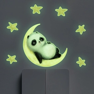 Luminous wall sticker showing a cute panda on a yellow moon with stars on grey wall