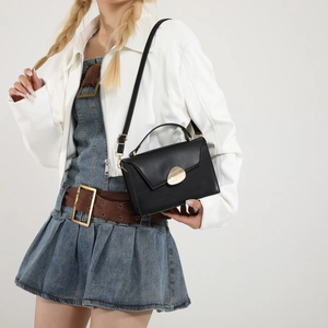 Chic black PU leather crossbody handbag for women with stylish golden pebble clasp