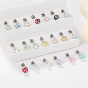 Multiple colors of 8mm rose-cut crystal stud earrings displayed on white steps
