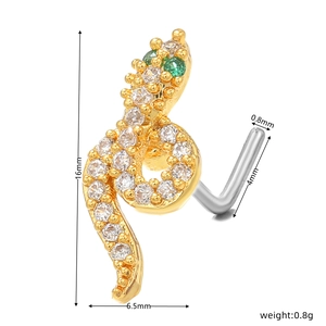 Detailed view of gold snake nose stud with clear crystals and green gem eyes
