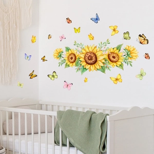 Nursery wall decor featuring sunflower and colorful butterfly stickers over a baby crib