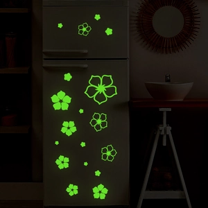 Luminous flower wall stickers glowing in the dark with green fluorescent effect on a wall
