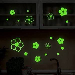 Luminous green flower wall stickers glowing in a dark kitchen setting for decoration