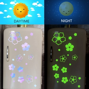Luminous flower stickers showing day laser rainbow effect and night green glow contrast