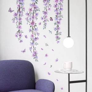 Detail view of purple wisteria vine wall stickers above a matching purple sofa