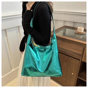 Metallic green tote bag in shiny PU leather shown in a casual lifestyle setting