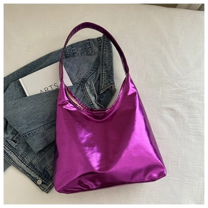 Macro shot of large purple metallic PU tote bag on blue denim and white sheets