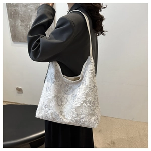 Detailed close-up of white lace floral texture on large canvas tote bag with slim straps