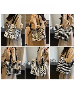 Multi-angle view of large canvas tote bag with abstract black and white doodle prints