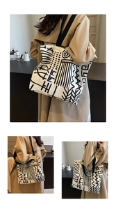 Detail of canvas tote bag with abstract graffiti print and black shoulder straps