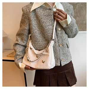 White pleated underarm bag with gold butterfly accents and versatile chain strap