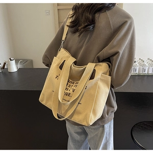 Retro khaki canvas tote bag for women featuring a spacious interior and adjustable strap