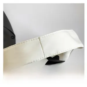 Close-up of wide cream canvas shoulder strap with reinforced stitching and star print