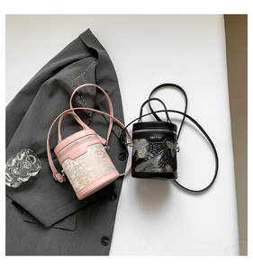 Detail of pink and black mini cylinder bags with floral and classic architecture prints