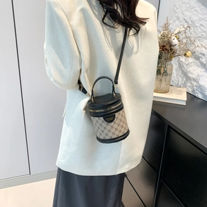 Classic cylinder crossbody bag with khaki monogram pattern and black leather trim for women