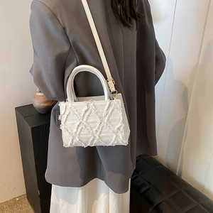 White denim crossbody bag with quilted frayed texture and gold metal hardware for women
