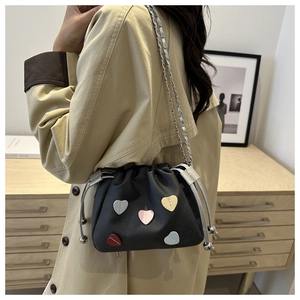 Sweet black heart-patterned drawstring bucket bag with colorful accents on model
