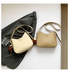 Hobo bags in cream and khaki with cute teddy bear pendants and adjustable straps