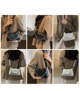 Chic women shoulder bag featuring a stylish bow knot and metallic chain details