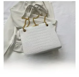 Detail of white crocodile pattern leather tote with gold chains and size comparison
