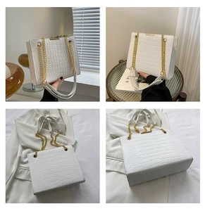 Close-up of white crocodile pattern tote bag with gold chain and premium PU leather texture