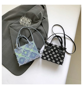 Detail of denim and checkerboard mini bags with star patches and frayed tassel edges