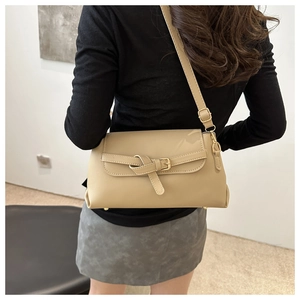 Rear view of khaki bow-knot crossbody bag on model showing size and fit in minimalist setting