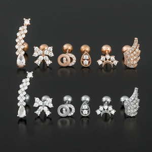 Set de pendientes de ala y celestiales en titanio con circonitas en oro rosa y plata pulida