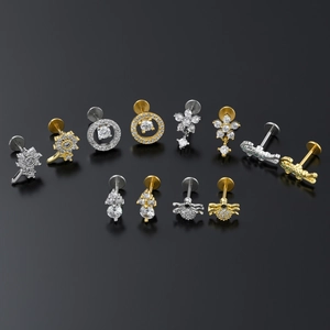 Floral and spider surgical steel labret stud set with crystals on black background