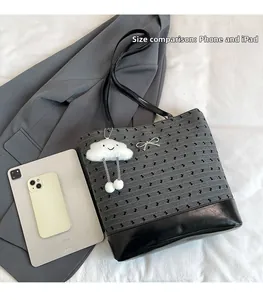 Detail of grey striped tote bag with bow charm, showing 11-inch iPad and phone size comparison