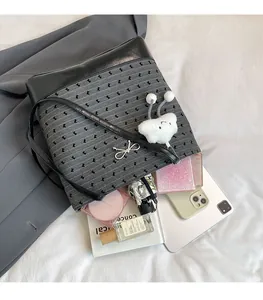Large gray canvas tote bag showing interior space with tablet and cosmetics