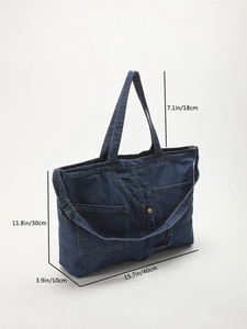 Detailed view of blue denim tote bag dimensions featuring two front pockets and strap