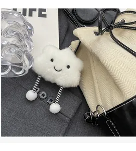 Detailed view of cloud plush charm with smiley embroidery on canvas shoulder bag