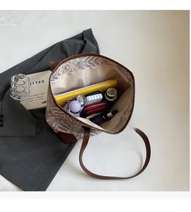 Spacious interior of a vintage plaid tote bag showing ample storage for daily essentials