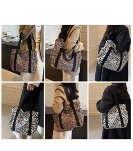 Macro shot of stylish leopard print tote bag with black strap and side pocket detail