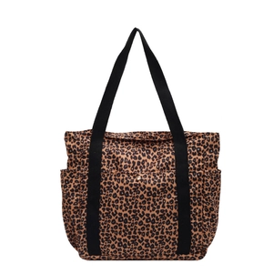 Large leopard print canvas tote bag with black straps and gold snap button closure