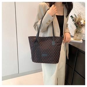 Sac fourre-tout noir à motifs de cœurs rouges et nœud en dentelle sur mannequin