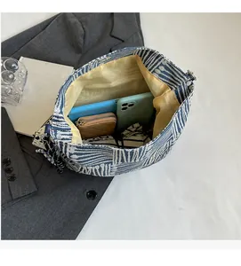 Large capacity striped tote bag with yellow lining showing spacious interior storage