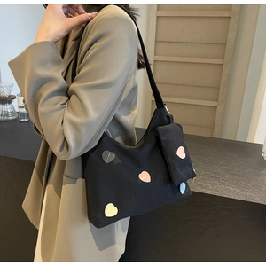 Minimalist black canvas tote bag with colorful heart patterns and matching small pouch